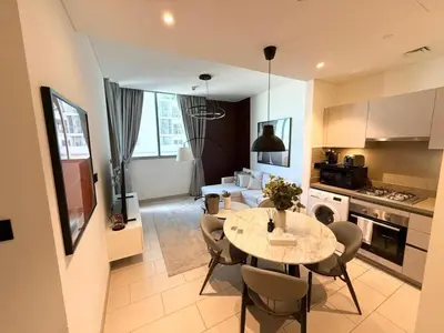 a kitchen and dining room with a table and chairs at Great Location Near City Modern Sleeps 4 Guests in Dubai