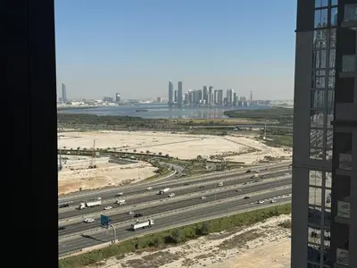 a view of a highway with a city in the background at Great Location Near City Modern Sleeps 4 Guests in Dubai