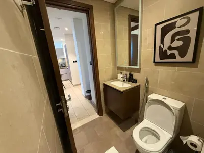 a bathroom with a white toilet and a sink at Great Location Near City Modern Sleeps 4 Guests in Dubai