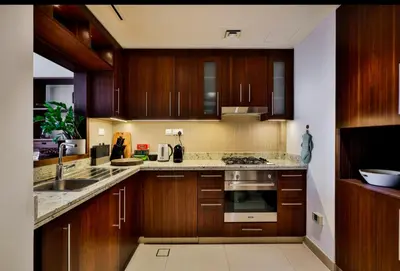 a kitchen with wooden cabinets and a stove top oven at 