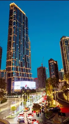 a city with cars parked in front of tall buildings at 