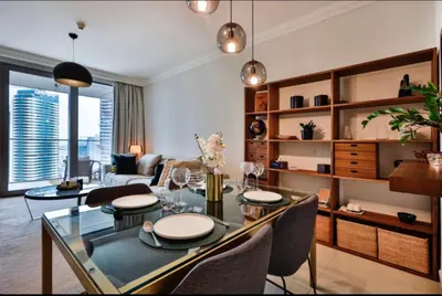 a living room with a glass table and chairs at 