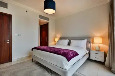 a bedroom with a large bed with a purple blanket at 