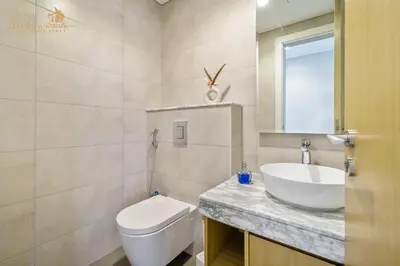 a bathroom with a white toilet and a sink at Luxury Sea View High Floor 3Bhk in Dubai