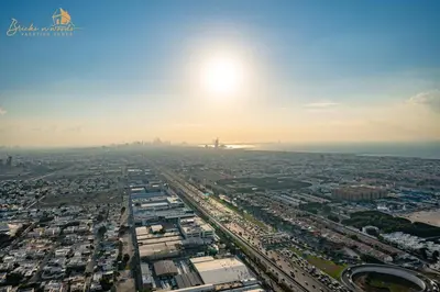 an aerial view of a city with the sun in the sky at Luxury Sea View High Floor 3Bhk in Dubai