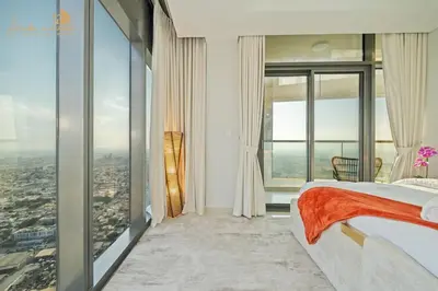 a bedroom with a view of a city at Luxury Sea View High Floor 3Bhk in Dubai