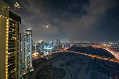 a view of a city at night with buildings at Luxury Sea View High Floor 3Bhk in Dubai