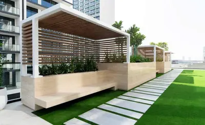 a garden on the side of a building at Elegant 2br Jvc Private Pool, Balcony & Parking in Dubai