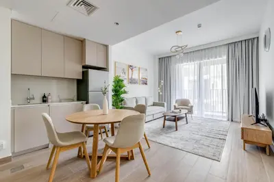 a kitchen and living room with a table and chairs at Knokey Dubai Creek Beach with Lagoon Pool access in Dubai