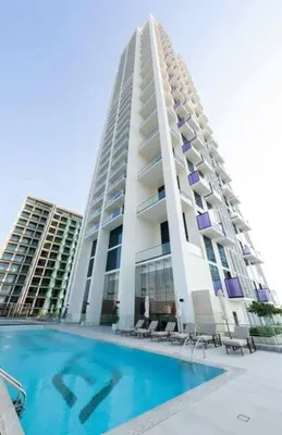 a large building with a swimming pool in front of it at Modern 1br In Jvc Balcony, Pool & Parking in Dubai