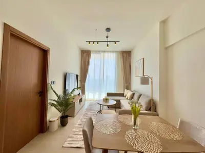 a living room with a couch and a table at Modern 1br In Jvc Balcony, Pool & Parking in Dubai