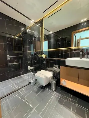 a bathroom with a toilet and a sink and a mirror at Modern 1br In Jvc Balcony, Pool & Parking in Dubai