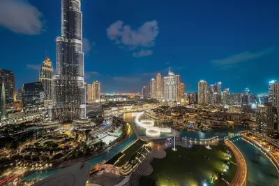a view of a large city at night at FIRST CLASS 2BR Burj Khalifa & Fountain view in Dubai