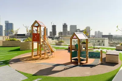 a playground in a park with a city in the background at GuestReady - Sky-High Luxury with a Private Pool in Dubai