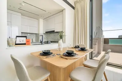 a dining room with a wooden table and chairs at GuestReady - Sky-High Luxury with a Private Pool in Dubai
