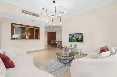 a living room with two white couches and a table at FIRST CLASS 2BR Spectacular Fountain Views in Dubai
