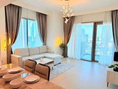 a living room with a couch and a table at 2 bedroom apartment infront of Dubai mall by Aventine homes in Dubai