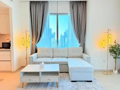 a living room with a couch and a table at 2 bedroom apartment infront of Dubai mall by Aventine homes in Dubai