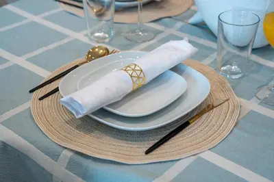 a plate with a rolled up napkin on a table at Burj Royale Lux 2-bedroom apartment with the best Burj Khalifa view in Dubai
