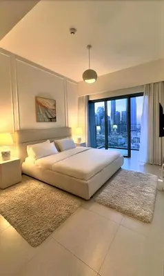 a bedroom with a large bed and a large window at Burj Royale Lux 2-bedroom apartment with the best Burj Khalifa view in Dubai