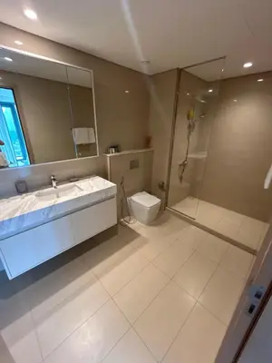a bathroom with a shower and a sink and a toilet at Burj Royale Lux 2-bedroom apartment with the best Burj Khalifa view in Dubai