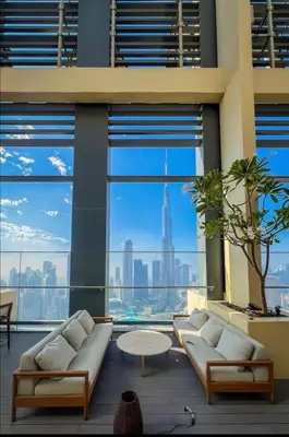 a living room with a large window with a view of the city at Burj Royale Lux 2-bedroom apartment with the best Burj Khalifa view in Dubai