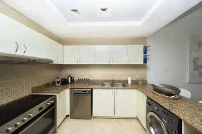 a kitchen with a sink and a dishwasher at 2 Bed in Atlantic Tower 2 by PK Holidays in Dubai