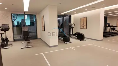 a gym with treadmills and exercise equipment in a building at Dubai Harbour & Sea Views 1 BR Near Key Landmarks, Marina Vista T1, Emaar Beachfront by Deluxe Holiday Homes in Dubai