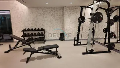a gym with several tread machines in a room at Dubai Harbour & Sea Views 1 BR Near Key Landmarks, Marina Vista T1, Emaar Beachfront by Deluxe Holiday Homes in Dubai