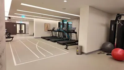 a gym with a basketball court and treadmills at Dubai Harbour & Sea Views 1 BR Near Key Landmarks, Marina Vista T1, Emaar Beachfront by Deluxe Holiday Homes in Dubai