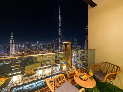 a balcony with a view of a city at night at Brand New! Downtown views located on Dubai Mall in Dubai