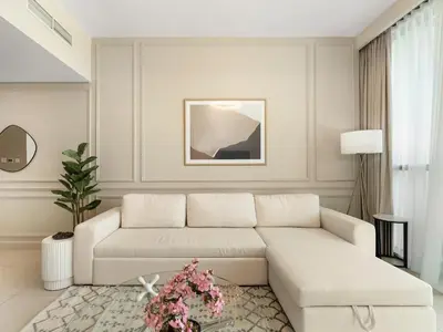 a living room with a white couch and a table at Brand New! Downtown views located on Dubai Mall in Dubai