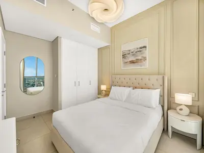 a bedroom with a white bed and a window at Brand New! Downtown views located on Dubai Mall in Dubai