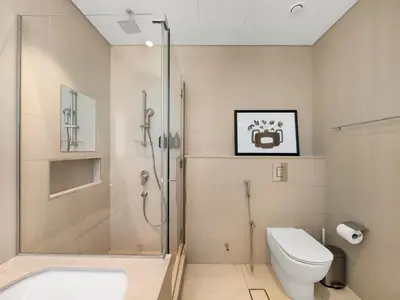 a bathroom with a shower and a toilet and a sink at Brand New! Downtown views located on Dubai Mall in Dubai