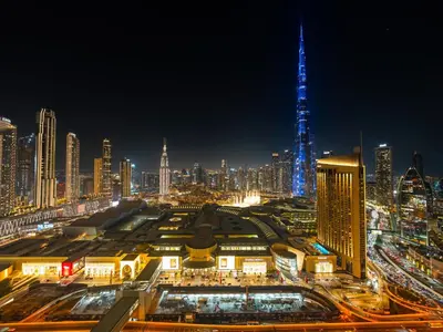 a view of a city at night with a tall building at Brand New! Downtown views located on Dubai Mall in Dubai