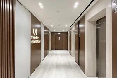 a corridor of a hotel with a sign on the wall at Large New Apartment Pool in JVC Community in Dubai
