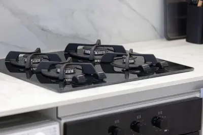 a black stove top in a kitchen at Large New Apartment Pool in JVC Community in Dubai