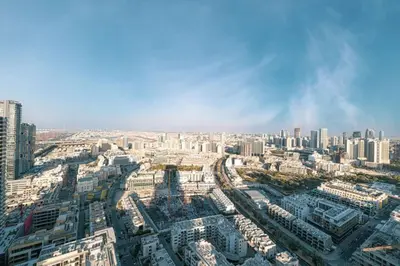 an aerial view of a city with tall buildings at Large New Apartment Pool in JVC Community in Dubai
