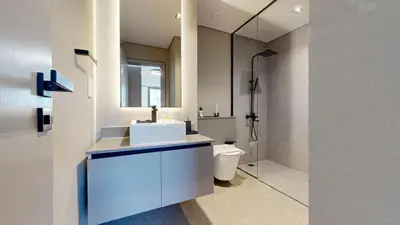 a bathroom with a sink and a toilet and a mirror at Mag Eye 890 - Airy One Bedroom in Meydan in Dubai