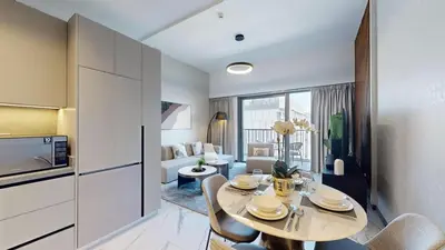 a kitchen and living room with a table and chairs at Mag Eye 890 - Airy One Bedroom in Meydan in Dubai