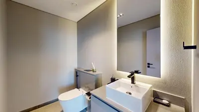 a bathroom with a sink and a toilet and a mirror at Mag Eye 890 - Airy One Bedroom in Meydan in Dubai