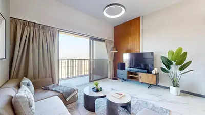 a living room with a couch and a tv at Mag Eye 900 - One Bedroom with Downtown Dubai View in Dubai