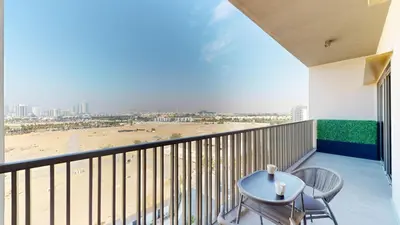 a balcony with a table and chairs and a beach at Mag Eye 900 - One Bedroom with Downtown Dubai View in Dubai