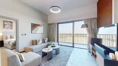 a living room with a couch and a tv at Mag Eye 900 - One Bedroom with Downtown Dubai View in Dubai