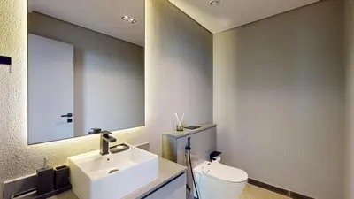 a bathroom with a sink and a toilet and a mirror at Mag Eye 910 - Magnificent One Bedroom in Meydan in Dubai