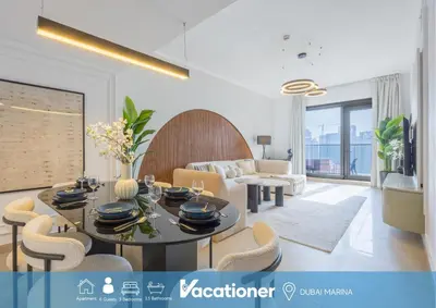 a living room with a dining table and chairs at Vacationer I Luxury 2BR I Marina Views I Close to JBR Beach I Sparkle Tower in Dubai