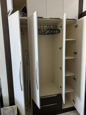 a white closet with white doors and shelves at Bayz Business Bay Lux Studio with Resort Amenities in Dubai