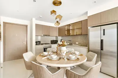 a kitchen with a dining room table and chairs at Luxury 2BR at Grand Bleu in Dubai