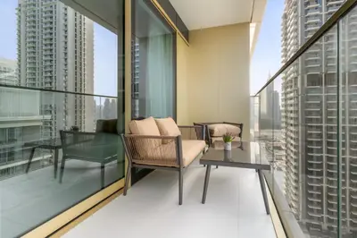 a balcony with a chair and a table at Luxury 2BR at Grand Bleu in Dubai
