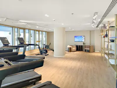 a gym with treadmills and exercise equipment in a room at Luxury 2BR at Grand Bleu in Dubai